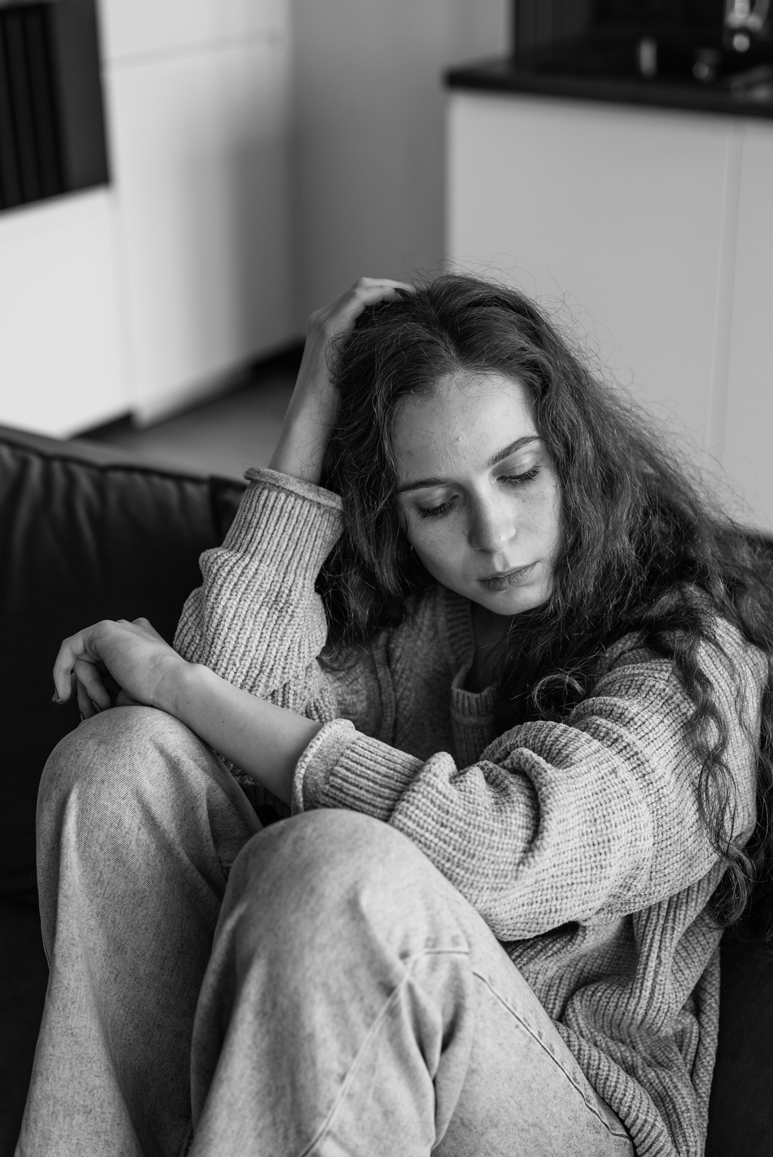 Woman in Sweater Sitting on Couch